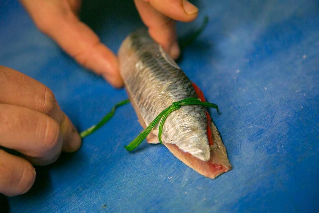 Atamos las sardinas con 2 ramitas de cebollino por cada extremo manteniendo firme el conjunto y las reservamos en frío.