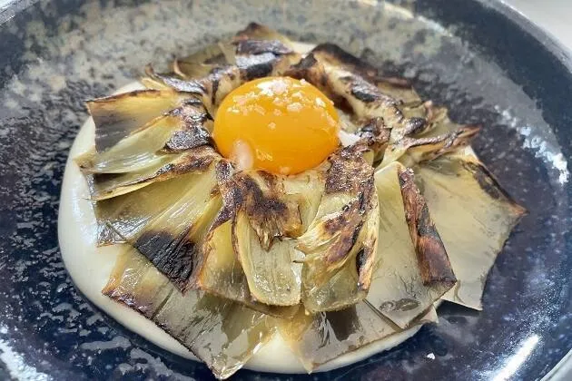 Alcachofa confitada, praliné salado de cacahuete, velo de papada y cremoso de patata 