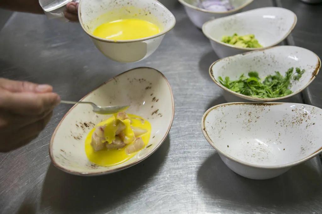 Ceviche de corvina con ají amarillo, aguacate y kikos 