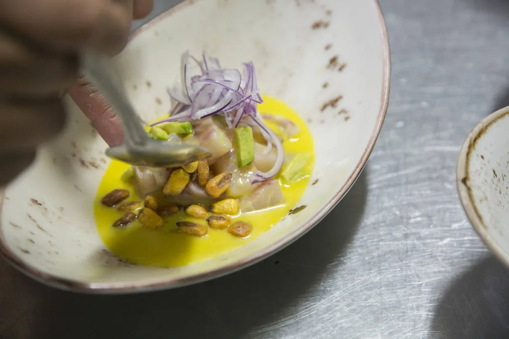 Ceviche de corvina con ají amarillo, aguacate y kikos 