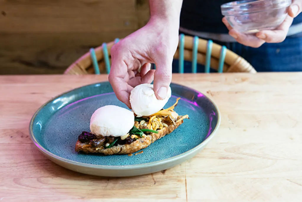 Huevos Benedict con setas, pasas, piñones y espinacas con holandesa de remolacha y kale